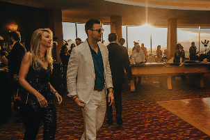Guests in formal attire at an evening event