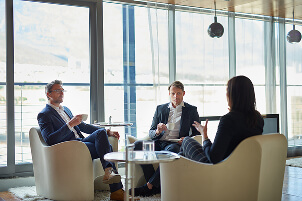 Professionals in a bright modern meeting lounge